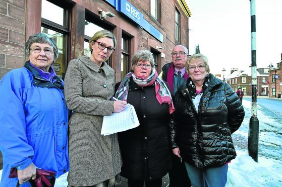MSP GILLIAN MARTIN SIGNS A PETITION TO KEEP THE RBS BRANCH IN TURRIFF OPEN WITH (L TO R) ANNETTE STEPHEN, COMMUNITY COUNCIL, MARGE CHALMERS, TURRIFF AND DISTRICT BUSINESS ASSOCIATION CHAIR, CLLR ALASTAIR FORSYTH AND COMMUNITY COUNCILLOR ROSE LOGAN.