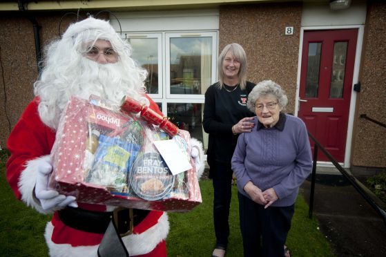 The Brander Arms in Lossiemouth has delivered more than 80 food parcels to pensioners in the town. Pictured, from left: Ryan Edwards, landlady Lynn Mitchell, Helen Edwards.