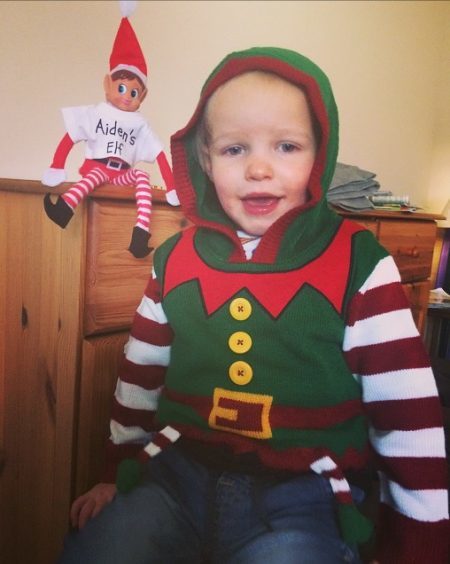 Aiden with his little elf pal. Sent in by Amy Roberts.