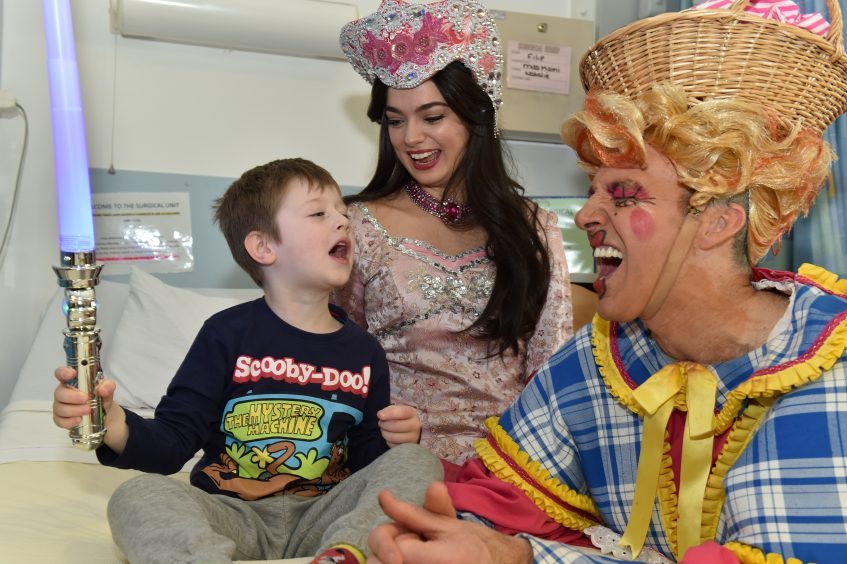 Filip , 5 with  (from left) Lisa-Anne Wood (Princess Jasmine) and Alan McHugh (Widow Twankey).