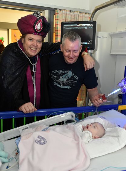 Jimmy Osmond (Abanazar) with James Barrett and Mayas Marie (7 months).