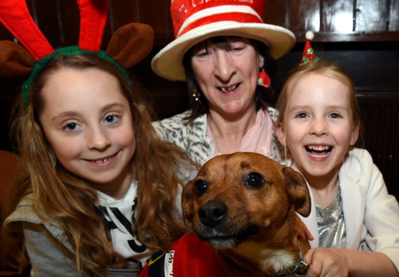 From left: Emily Killicote, Yvonne Killicote and Amy Killicote with Woody.