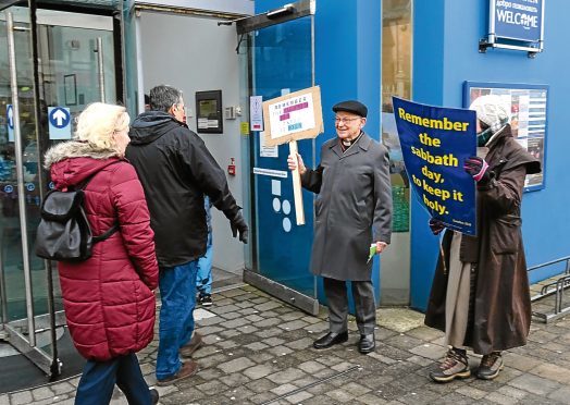 Protesters outside Stornoway Cinema as it opens for the first time on the Sabbath day.