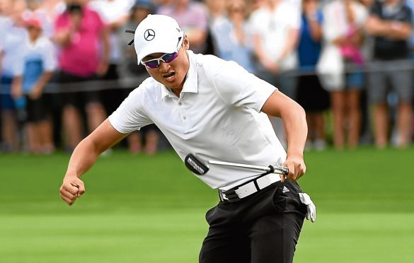 DUBAI, UNITED ARAB EMIRATES - JANUARY 28:  Haotong Li of China celebrates his birdie and victory on the 18th green during the final round on day four of the Omega Dubai Desert Classic at Emirates Golf Club on January 28, 2018 in Dubai, United Arab Emirates.  (Photo by Ross Kinnaird/Getty Images)