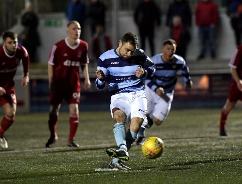 Dee's Jamie Watt scores from the penalty spot.