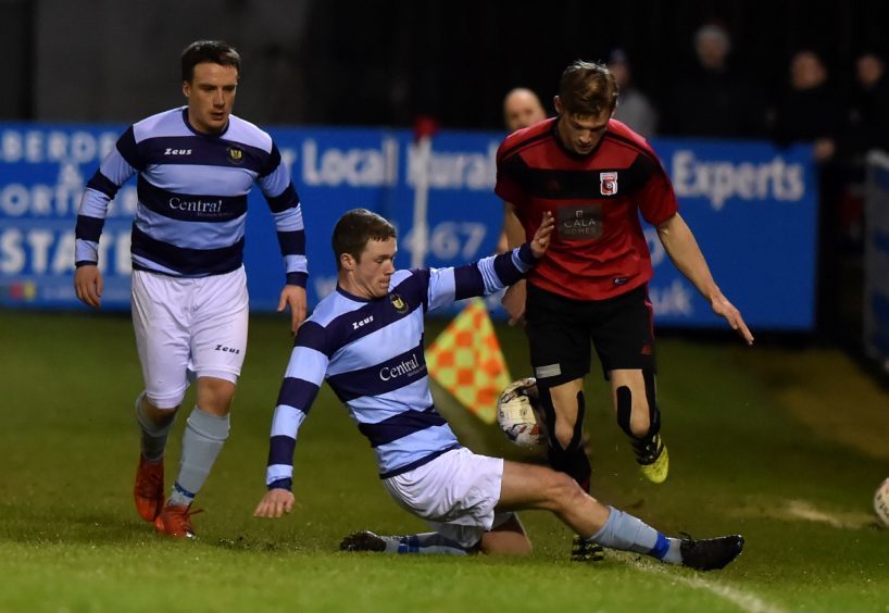 Picture of (L-R) Mark Gilmour slidding in on Andrew Hunter.