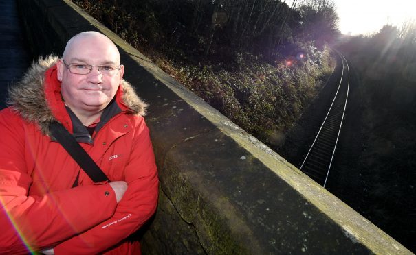 Aberdeen City Councillor Dell Henrickson on the bridge at Powis Terrace, above the railway line north from Aberdeen Station.