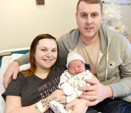 Hours old Harry Ferguson with mum Amy Coull and dad Craig Ferguson. Picture by Sandy McCook.