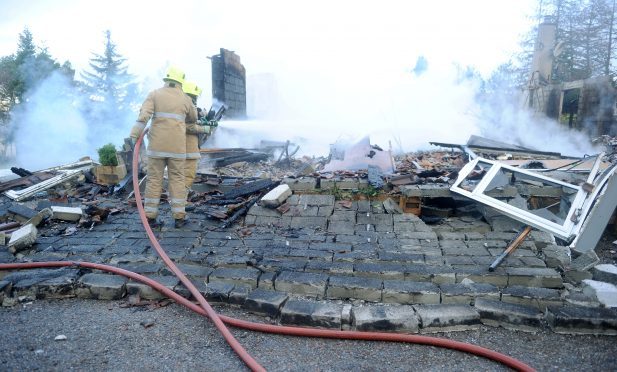 Firefighters continue to extinguish the fire which destroyed a house in the Foxhole area of Kiltarlity. Picture by Sandy McCook