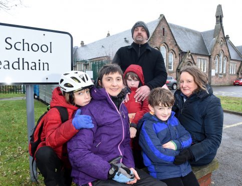 Concerns over the implementation of a cluster group of Bishop Eden and Central Primary Schools in Inverness.  Concerned parents, (L-R) Esther Dickinson, Convener of the Parent Council with her son Lewis, Roy Graham with his son James and Helen Smith, vice convener with her son David.