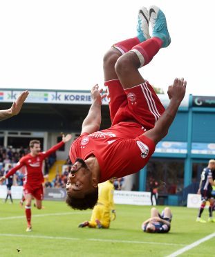 Aberdeen's Shay Logan celebrates scoring in Dingwall in August