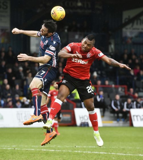 Ross County's Ross Draper (L) in action with Rangers' Alfredo Morelos.