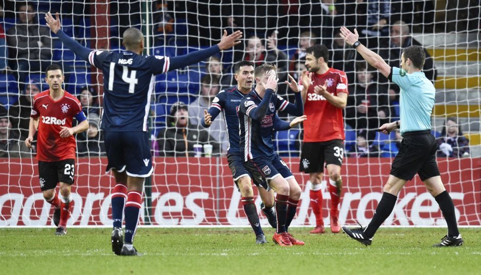 The Ross County players claim for a penalty award.