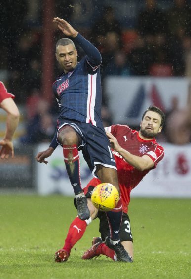 Ross Countys David N'gog (left) and Rangers' Russell Martin battle for the ball