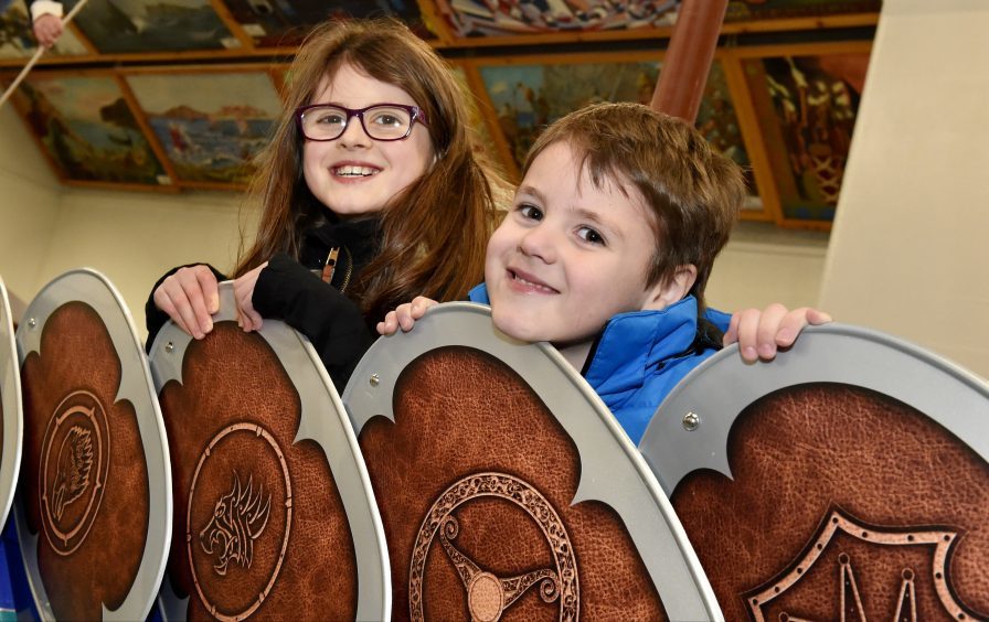 Isla Scolley, 9, with brother Jordan 5, admire the detail of the shields on the side of the Galley.
Picture by Colin Rennie