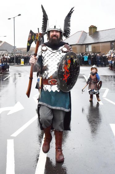 Shetland - Up Helly Aa - 2018 - Tuesday morning - The parade. Guizer Jarl Stewart Jamieson with one of the younger squad Odin Geddes, 4.
Picture by COLIN RENNIE  January 30, 2018.