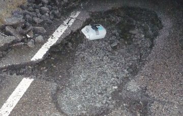 The huge pothole on the Muir of Ord to Tore road