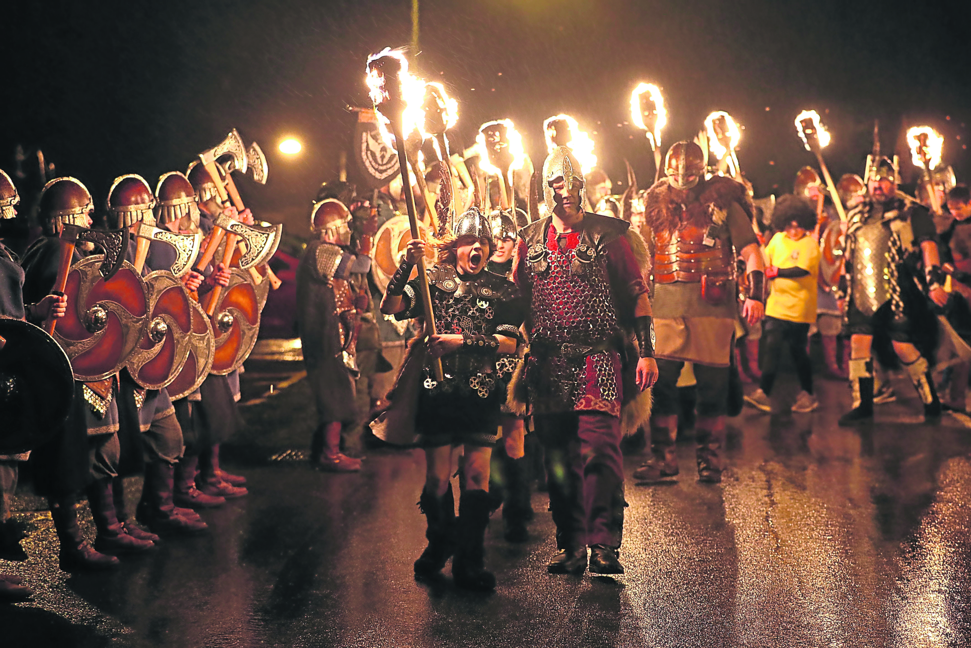 Members of the Junior Jarl Squad carry flaming torches through Lerwick