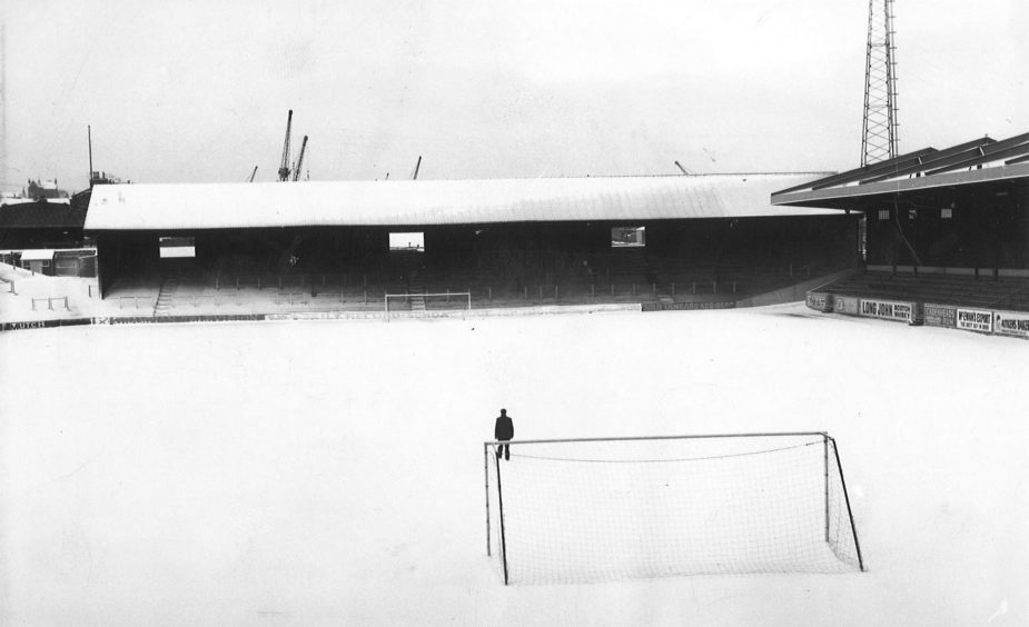 A solitary figure walks across the snowy pitch at Pittodrie in 1970.