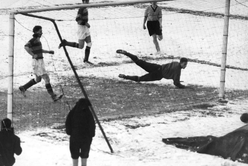 Aberdeen v Partick Thistle - match in the snow - Dons Winger Hather, scores their third goal
26th January 1959