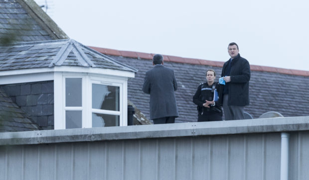 Police and fire personnel on the roof.
Picture: Derek Ironside / Newsline Media