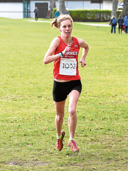 Jess Tullie crossing the finishing line