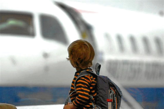 A young boy looks at an aircraft at Aberdeen Airport.