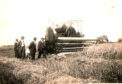 A Massey Harris combine 21 at work at Craigie farm in Fife during WWII
