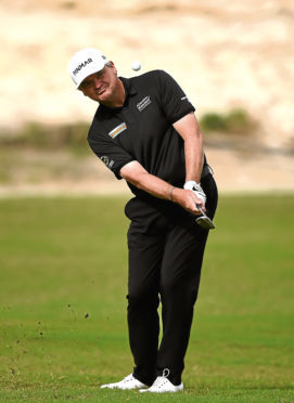 Paul Lawrie takes a shot from the 16th fairway prior to the Commercial Bank Qatar Masters at Doha Golf Club