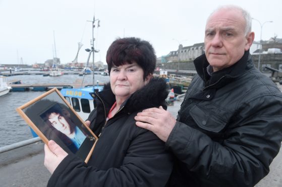 Hugh and June McLeod with a photograph of their late son Kevin