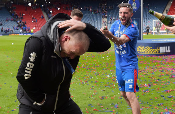 John Hughes is sprayed with champagne by captain Graeme Shinnie after ICT's cup triumph in 2015