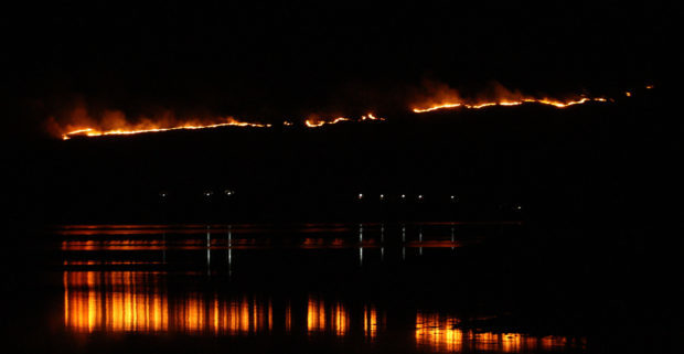 hill on fire above properties and creagan inn near appin argyll picture kevin mcglynn