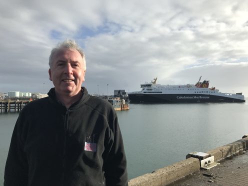 Calum MacDonald in Stornoway, with CalMac’s Loch Seaforth behind him.