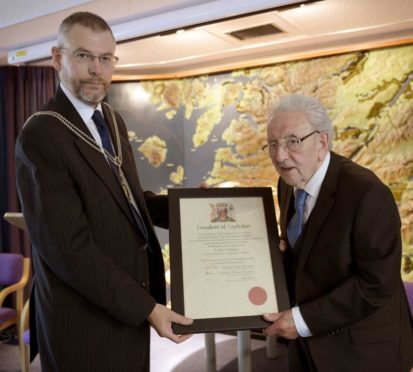 Colin Neilson (right) is presented with the Freedom of Lochaber Scroll by Councillor Thomas MacLennan. Picture:  Iain Ferguson, The Write Image