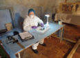 Sue Black working in a crypt at Wardlaw Mausoleum in Kirkhill, near Inverness, as experts have said that ancient human remains removed from the crypt were not those of notorious Jacobite supporting clan chief, but a headless woman. Picture: The Royal Society of Edinburgh/PA Wire