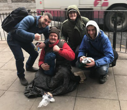 Lee McAllister hands out packages to homeless people in Aberdeen.