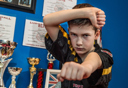 10 year old Kickboxing Aidan Lennan in his bedroom in Inverness.