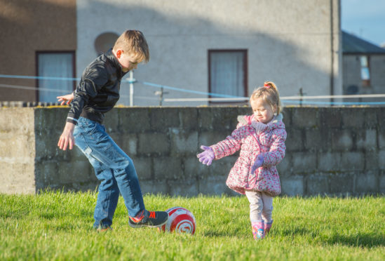 Noah Murray (left) and Lotte Cormack entertaining themselves with a football in absence of a playpark to play in.
Picture by Jason Hedges.
