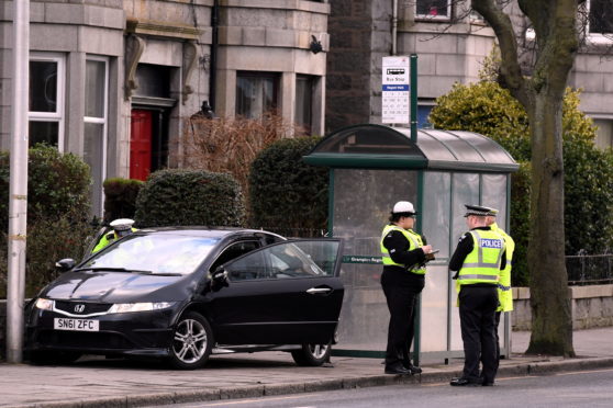 Police on the scene in King Street, near Aberdeen University.   
Picture by Kami Thomson.