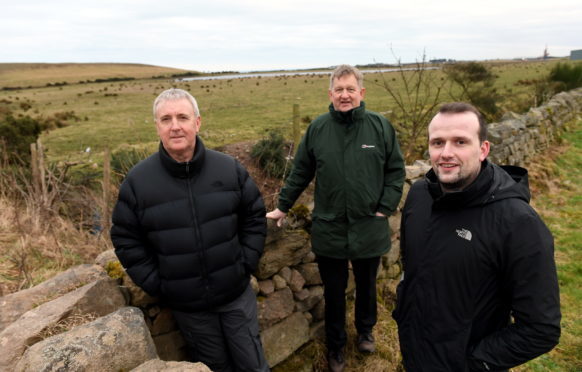 There have been calls for an all weather sports facility to be built in Cove in an area of land beside the Gateway Business Park next to the Cove Youth Football Club ground.     
Pictured (left to right) are community representative Raymond Davidson, Cllr Alex Nicoll and Cllr Stephen Flynn in front of the area they hope it could be placed.   
Picture by Kami Thomson.