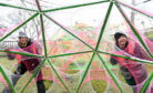 Artists Hannah Ayre (left) and Amanda Yates at one of their installations in the gardens.    
Picture by Kami Thomson
