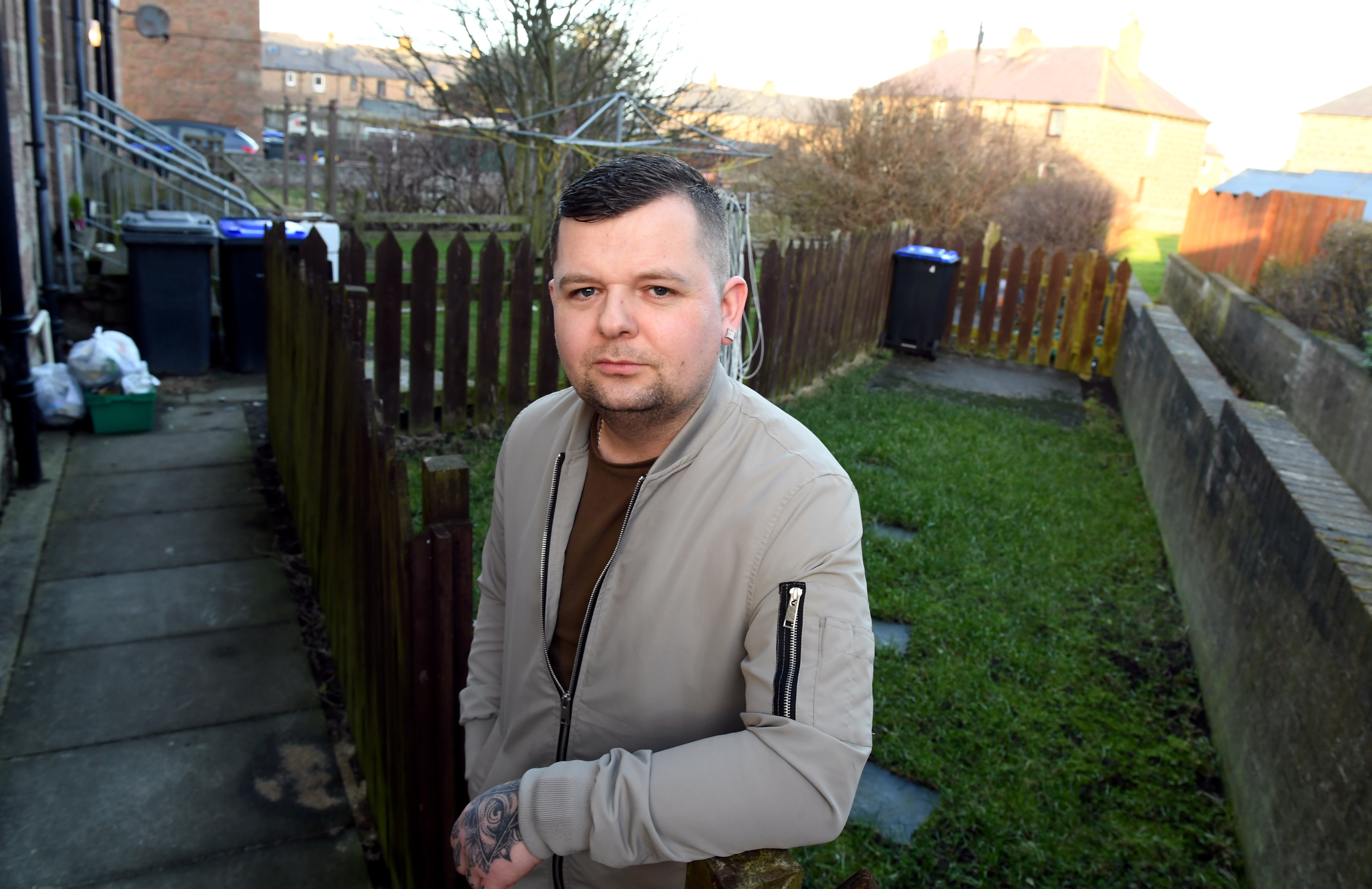 Jamie Findlay at his back garden at Churchill Drive, Peterhead, where drug users have been leaving used needles.