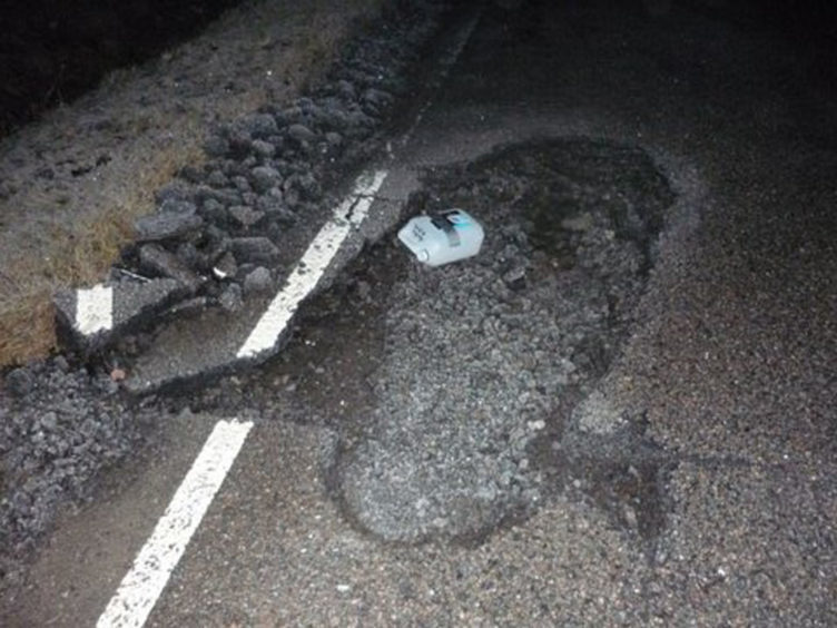 This pothole on the A832 between Muir of Ord and Tore caused £1,500 of damage and was described as the "size of a bathtub".
