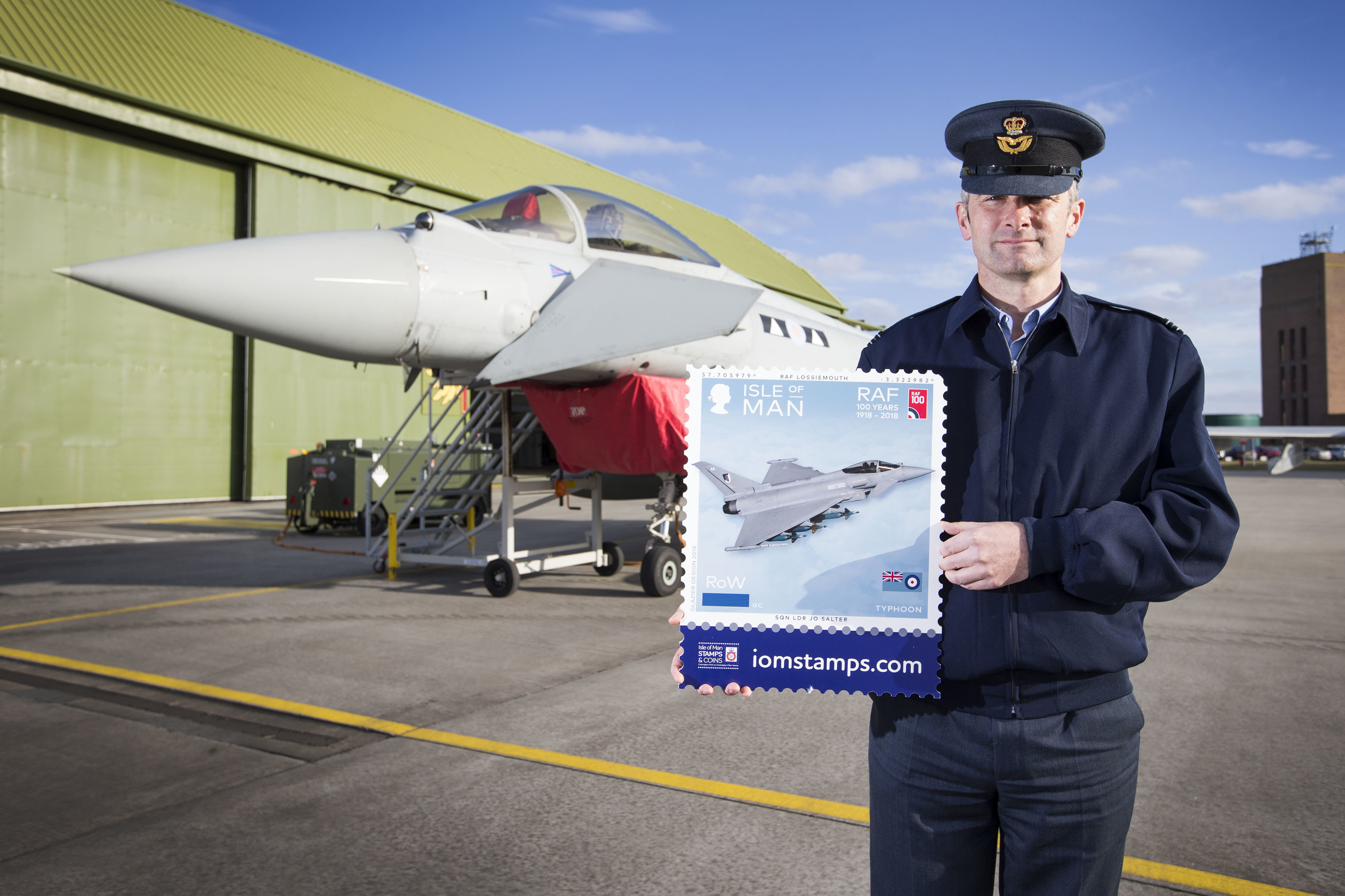 Flight Lieutenant Danny Streames with the stamp featuring a Typhoon jet.