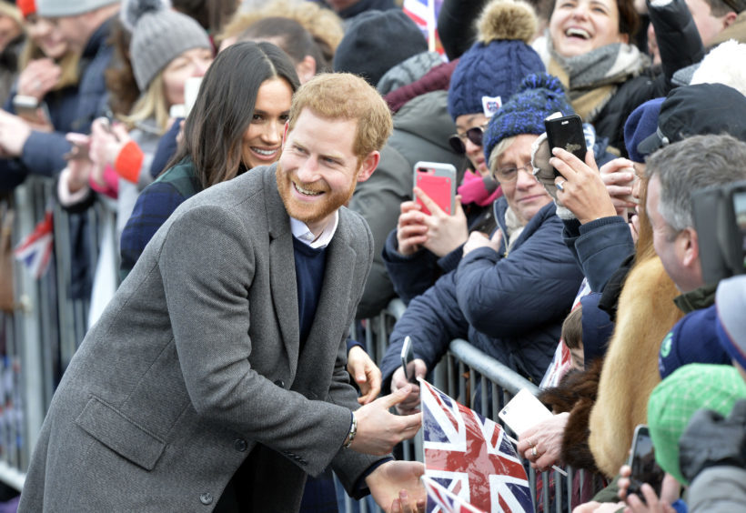 Prince Harry and Meghan Markle during a walkabout on the esplanade at Edinburgh Castle