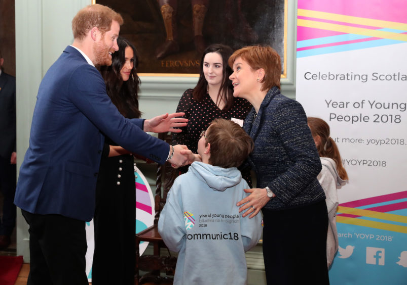 Prince Harry and Meghan Markle meet First Minister Nicola Sturgeon during a reception for young people at the Palace of Holyroodhouse, in Edinburgh