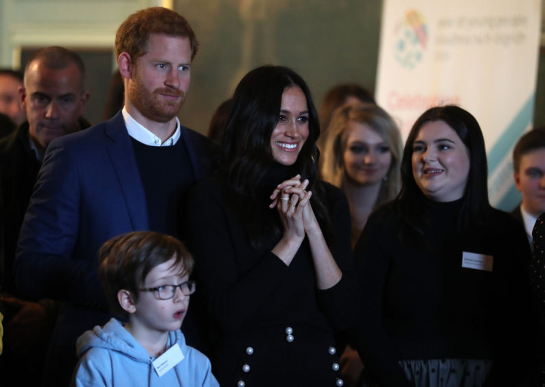 Prince Harry and Meghan Markle during a reception for young people at the Palace of Holyroodhouse, in Edinburgh, during their visit to Scotland. PRESS ASSOCIATION Photo. Picture date: Tuesday January 23, 2018. See PA story ROYAL Harry. Photo credit should read: Andrew Milligan/PA Wire