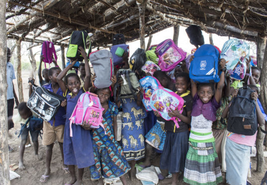Children from Ngabu Primary School in Malawi with some of the 500,000 bags given out by Mary's Meals which were donated by supporters to schools it helps in the African country.