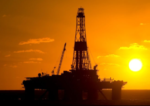 An oil rig at sunset