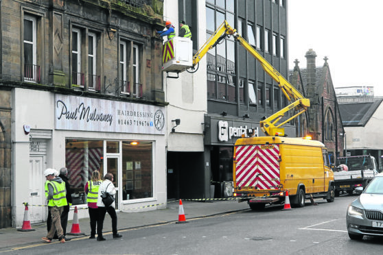 A section of pavement was closed off on Academy Street on Thursday afternoon after masonry fell from a building next to the Penta Hotel.